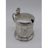A Victorian silver mustard pot, crest to lid, blue glass liner, hallmarked London, 1863, 125g, H.8.