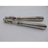 A pair of early 20th century silver nutcrackers, hallmarked Sheffield, 1926, maker GH, 216g, L.18.