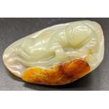 A Chinese jade carving of a man within a leaf, L.6cm