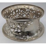 An Edwardian silver potato ring, decorated with flora and fauna and figures, vacant cartouche,