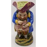 A 19th century porcelain toby jug taking snuff, marks to base