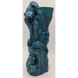 A 19th century Chinese blue glazed porcelain study of a dog of fo within a tree