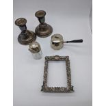 A collection of silver items to include a pair of dwarf candlesticks, hallmarked Birmingham, a