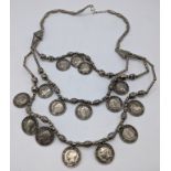 A Colonial Indian silver necklace with silver beads and coins