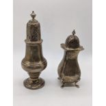 A silver pepper, hallmarked London, 1914, maker C.S. Harris & Sons Ltd, H.20.5cm, and a silver