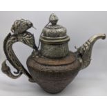 A Tibetan silver and copper teapot, the handle fashioned into a dragon, and the faceted spout