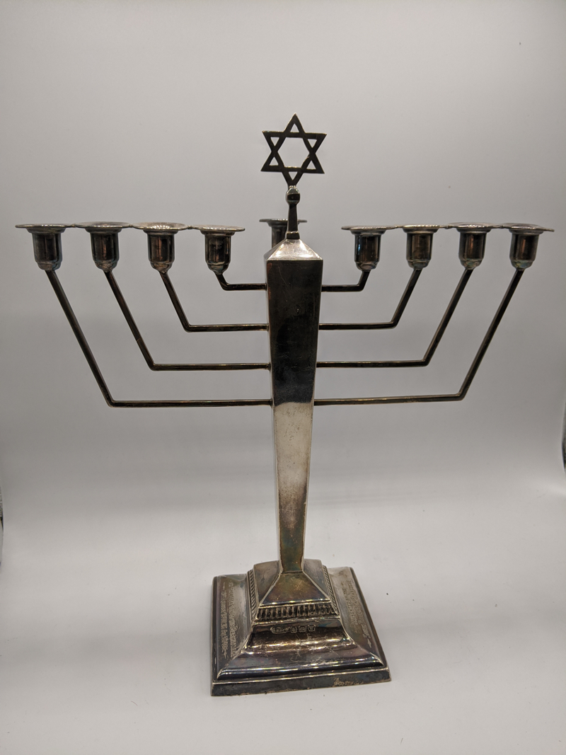 A silver menorah, Star of David finial, hallmarked Birmingham, 1946, engraved, 323g H.27cm