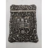 A 19th century silver card case, decorated with a castle and cathedral scene, deer crest, hallmarked