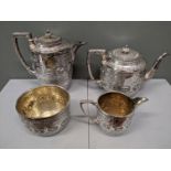 A four piece silver plated tea set with etched and embossed decoration, gilt interior