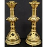 A pair of Gothic Revival brass candlesticks, mounted with stones, circa late 19th century, H.61cm