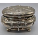 A late 19th century silver Etrog box, repousse embossed, raised on four bun feet, stamped 750 to