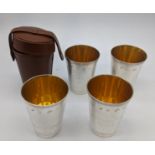 A set of four contemporary silver travel beaker with leather case, Birmingham hallmarks, gilt