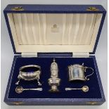 A Garrards & Co. Ltd cased set of silver tableware, hallmarked Sheffield, blue glass liners,