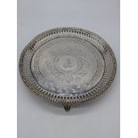 A Victorian silver salver, pierced outer with etched greek key border, central crest, raised on
