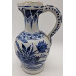 A 19th century or earlier Delft blue and white jug with floral patterns, H.19cm