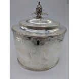 A George III silver tea caddy, crest to the front, vacant cartouche to the rear side, pineapple