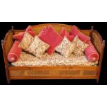 A bergere day bed settee, acorn finials and fluted columns, upholstery with pink birds, together
