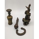 Four South Indian brass and bronze objects including a finial decorated with a bird and bells, H.