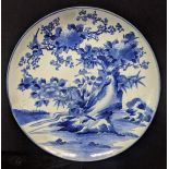 A large early 19th century Japanese blue and white charger decorated with birds, character marks