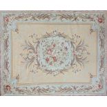 An Aubusson style embroidered rug with central floral motif