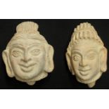 Two carved red sandstone terracotta heads of Hindu Shaivite Deities Shiva and Parvati, probably