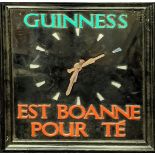 A Guinness wall clock by Smiths, Channel Island French