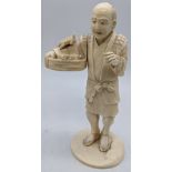 A Japanese Meiji period (1868-1912) ivory study of a man with a basket of turtles, signed to base,