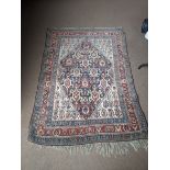 A large Persian rug, 225cm x 153cm