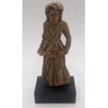 A Romano-Egyptian wood statuette of a woman wearing a flower garment and scarf, 1st century BC/AD,