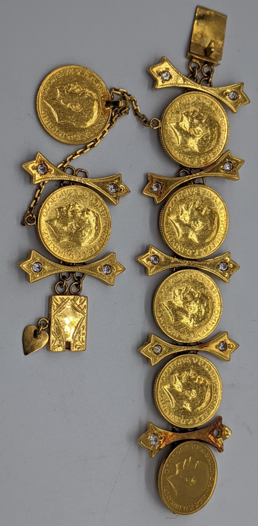 A gold and diamond bracelet mounted with 7 full sovereign coins, the links are unmarked but test as