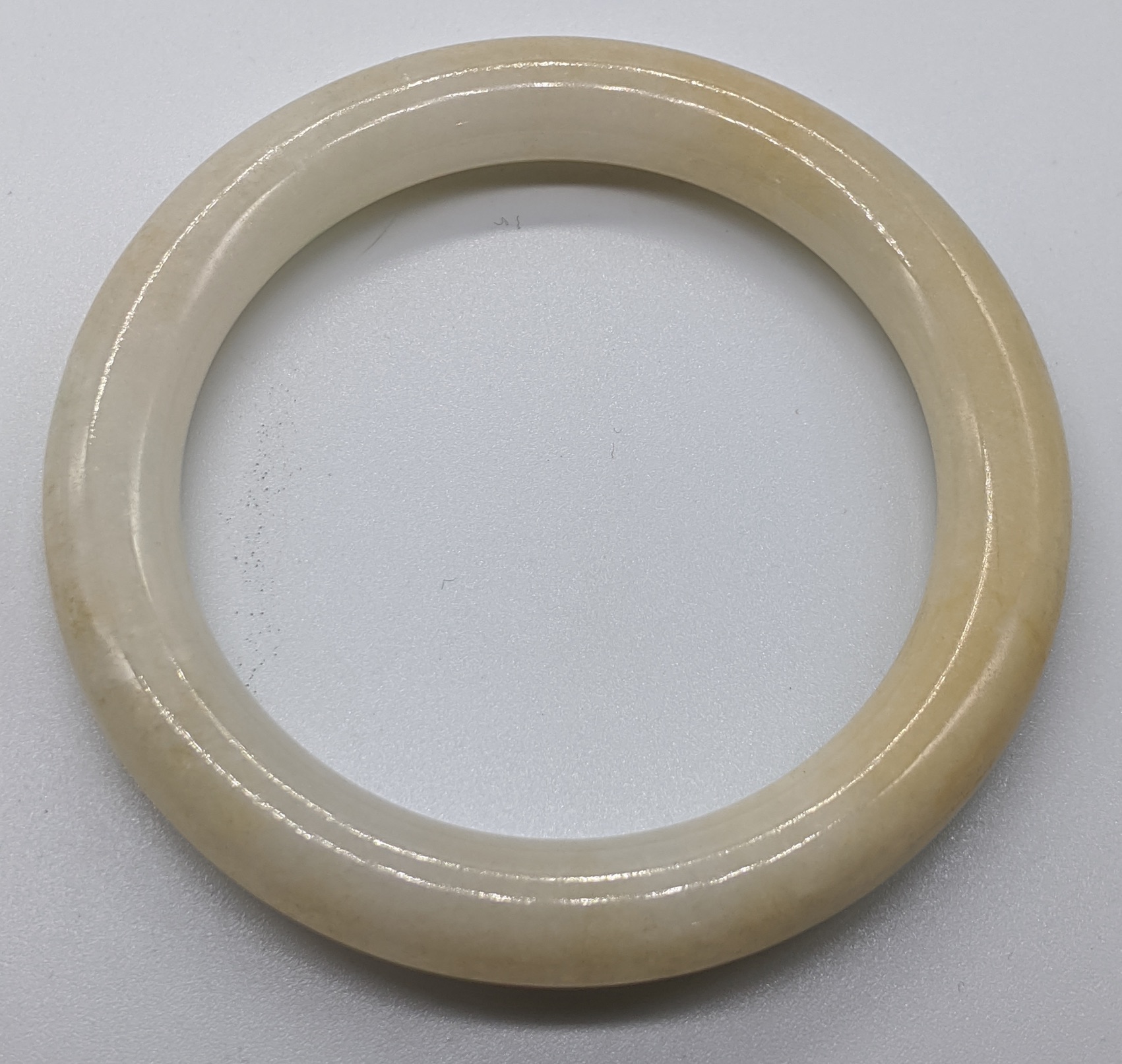 A Chinese white jade bangle, D.7.5cm