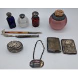 A collection of silver items to include a glass spherical match holder, 2 match cases, 3 silver