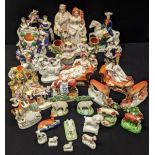 A large collection of Staffordshire pottery to include greyhounds, poodles etc.