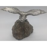 A silver sculpture of an eagle mounted on a rock, hallmarked London, 1981, maker BSEP, total item