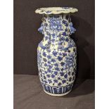 A Chinese 19th century blue and white vase, decorated with dragon, dogs of fo and floral splays, H.