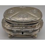 An Austrian silver box, embossed with floral splays, with key, marked 750 to base, 300g, H.11cm L.