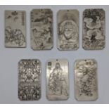 A set of 7 Chinese white metal tokens, 10cm x 5.5cm