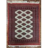 A Pakistani handmade rug, red border, 190cm x 130cm