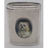 A silver vesta case mounted with enamel portrait of a Terrier dog, engine turned to front and
