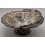 A large Victorian silver bowl, embossed with splays of thistles, swing handle with monogram,