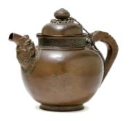 AN EMBOSSED COPPER TEAPOT.
