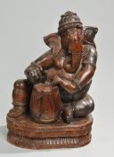 Skulptur des GaneshaHartholz, geschnitzt. Auf Lotossockel Darstellung des sitzenden Ganesha,