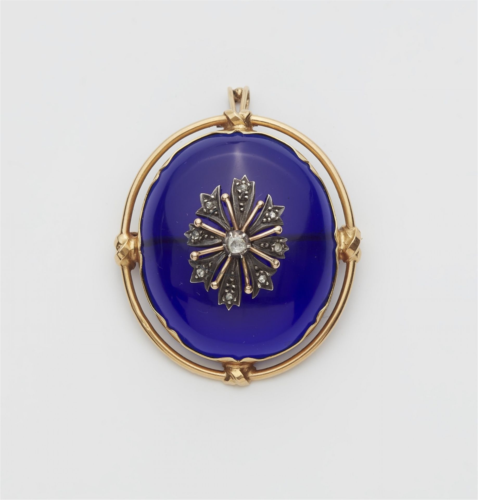 A 14k gold pendant brooch with a blue paste cabochon