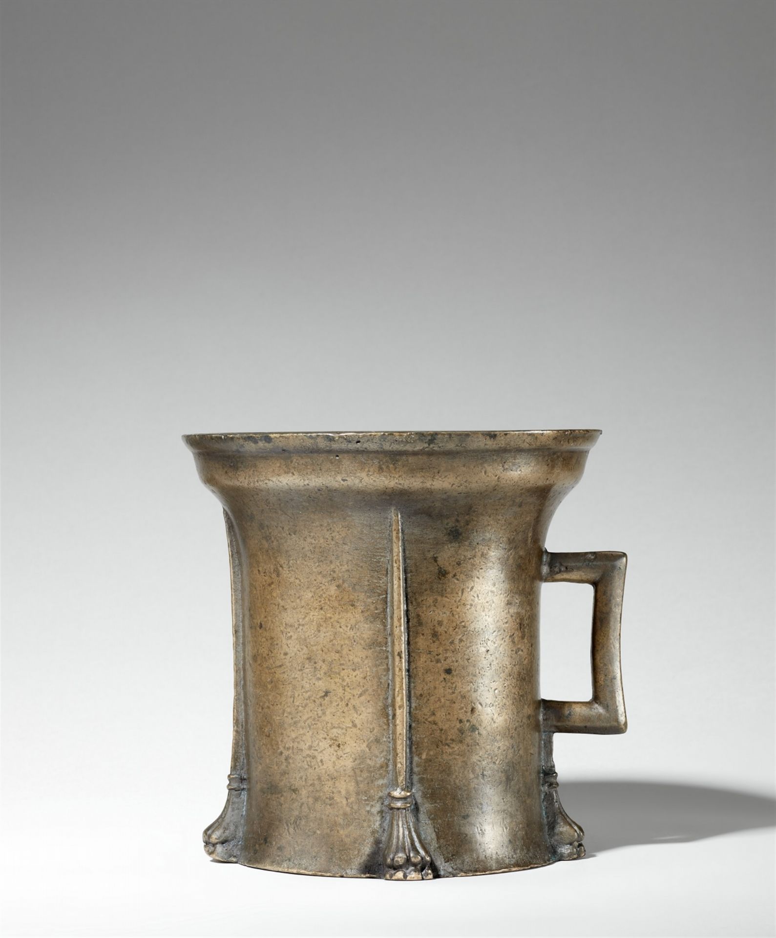 A magnificent Gothic single-handled mortar with lion's paw feet