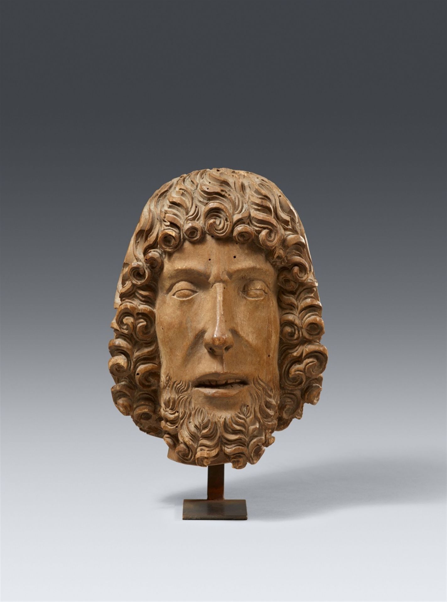 A late 15th century carved wood head, probably John the Baptist, presumably Southern Germany