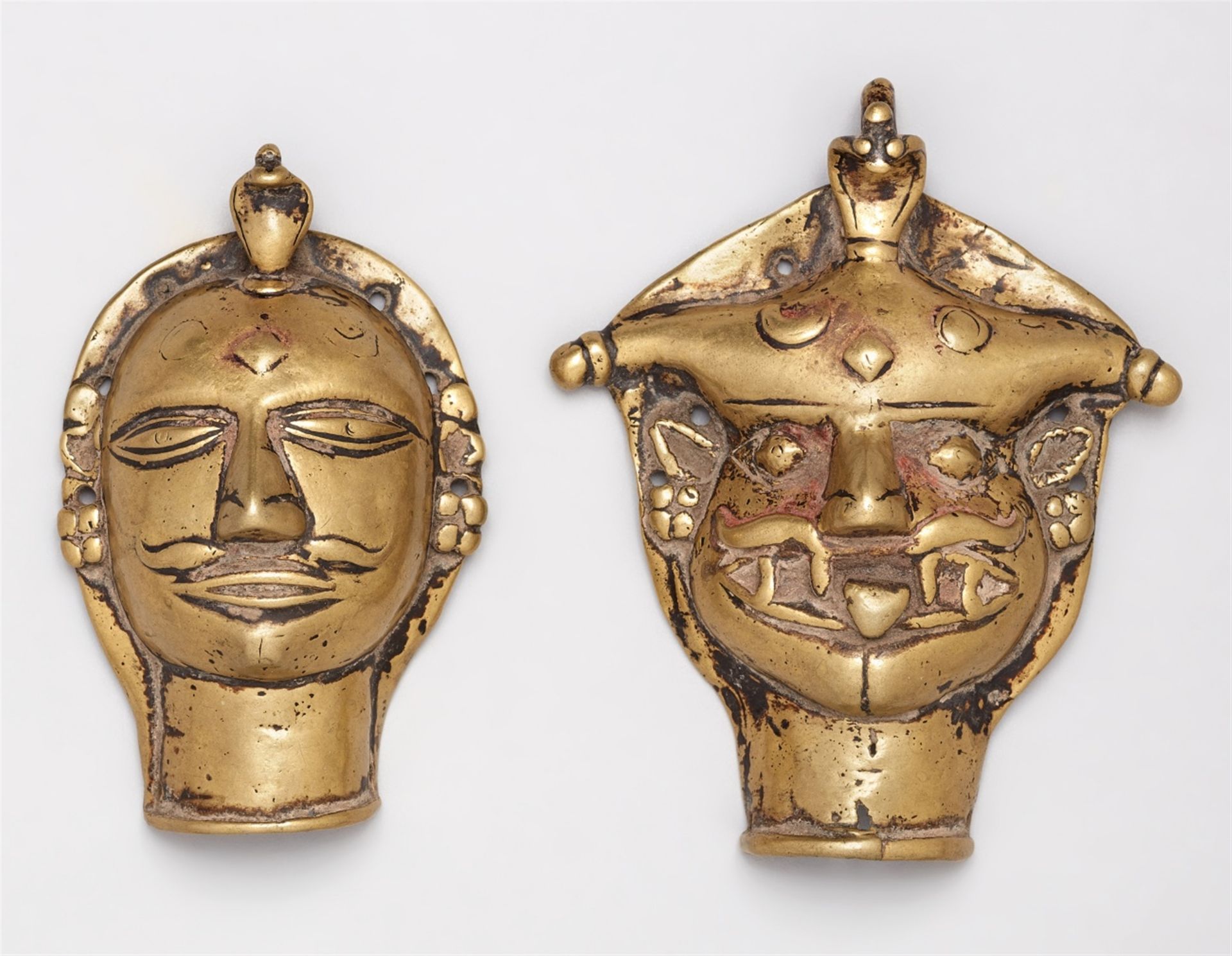 Two Maharashtra brass heads. Central India. 19th century