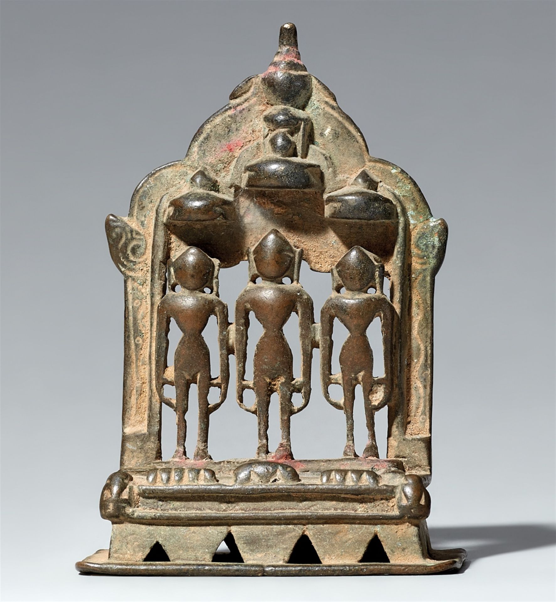 A small copper alloy Jain altar of three tirthankara. Western India, Gujarat. Dated by inscription 1
