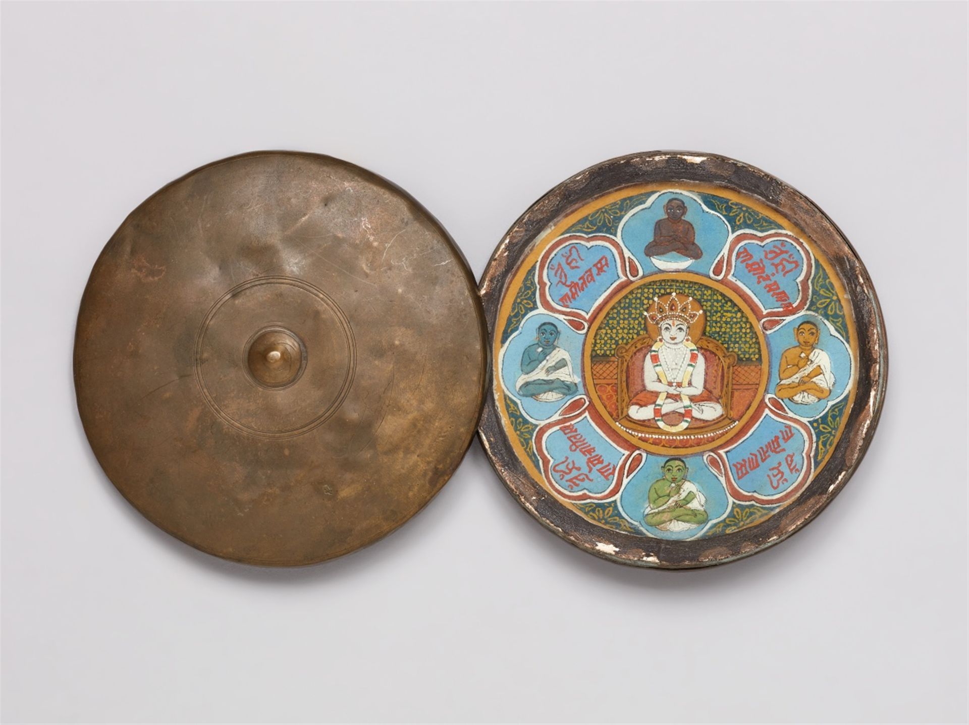 A portable Jain Shvetambara Siddhachakra. Pigments on paper, glass and a copper alloy container. Wes