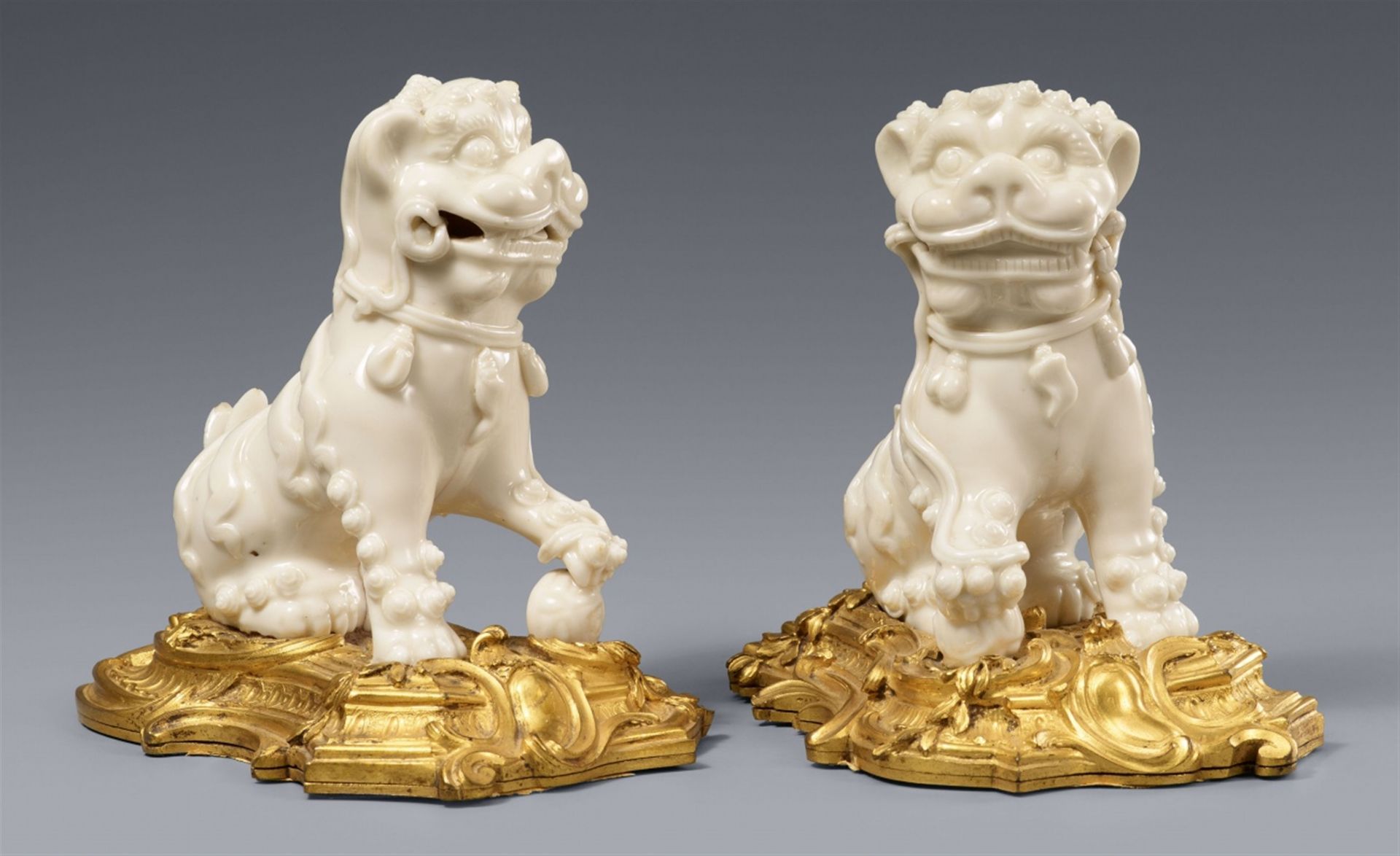 A pair of ormolu-mounted Dehua blanc de Chine lions. Kangxi period (1662-1722)