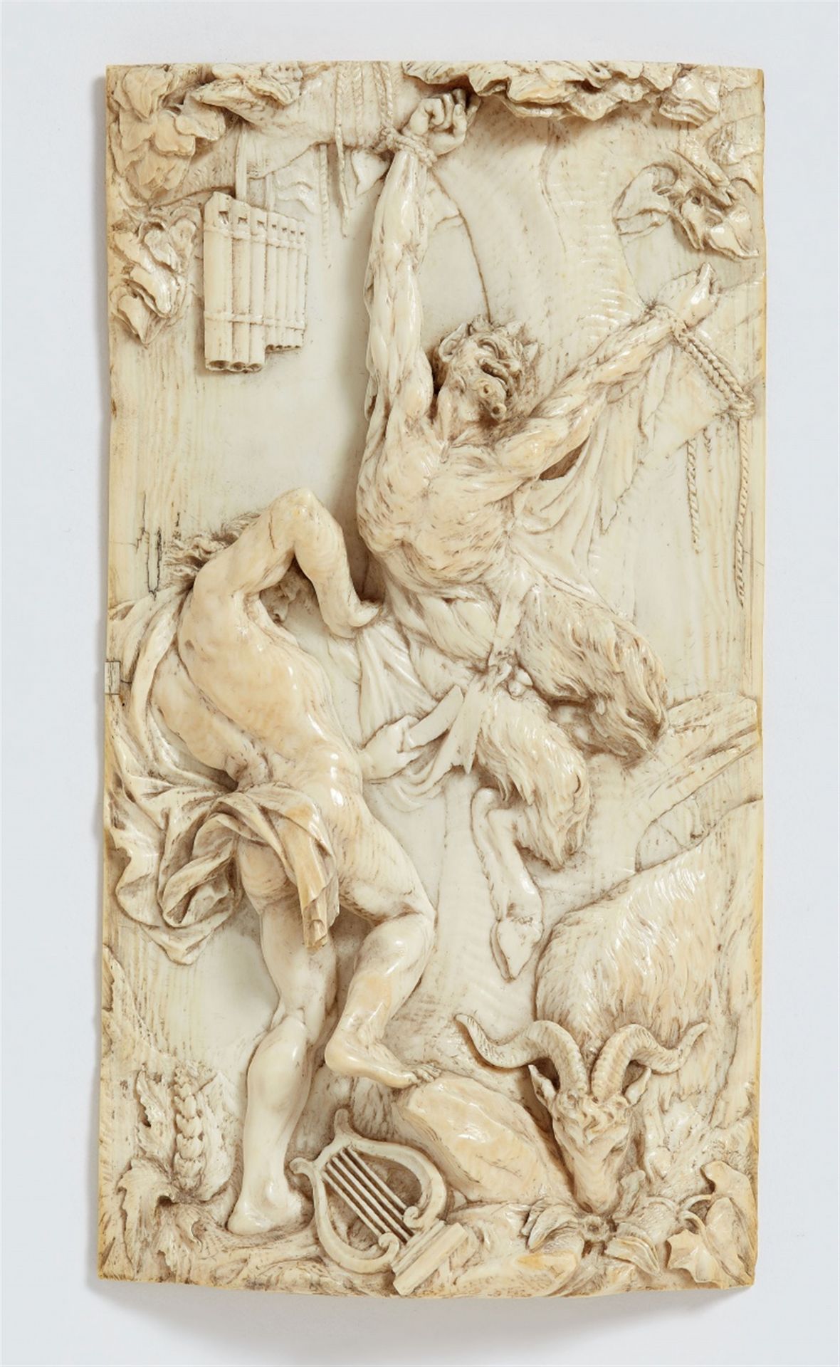 A carved ivory relief with the flaying of Marsyas, attributed to François van Bossuit